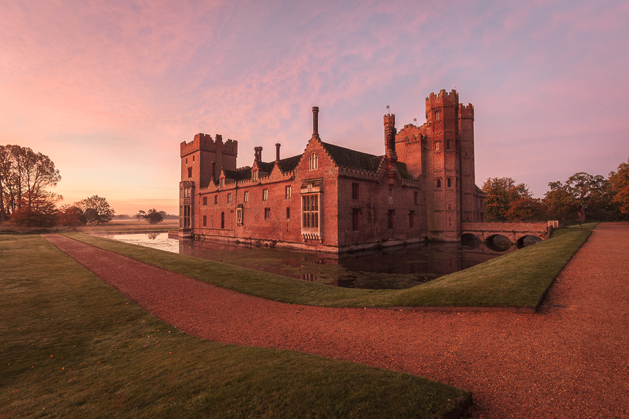 Oxburgh Hall in Norfolk glowing with the early morning light